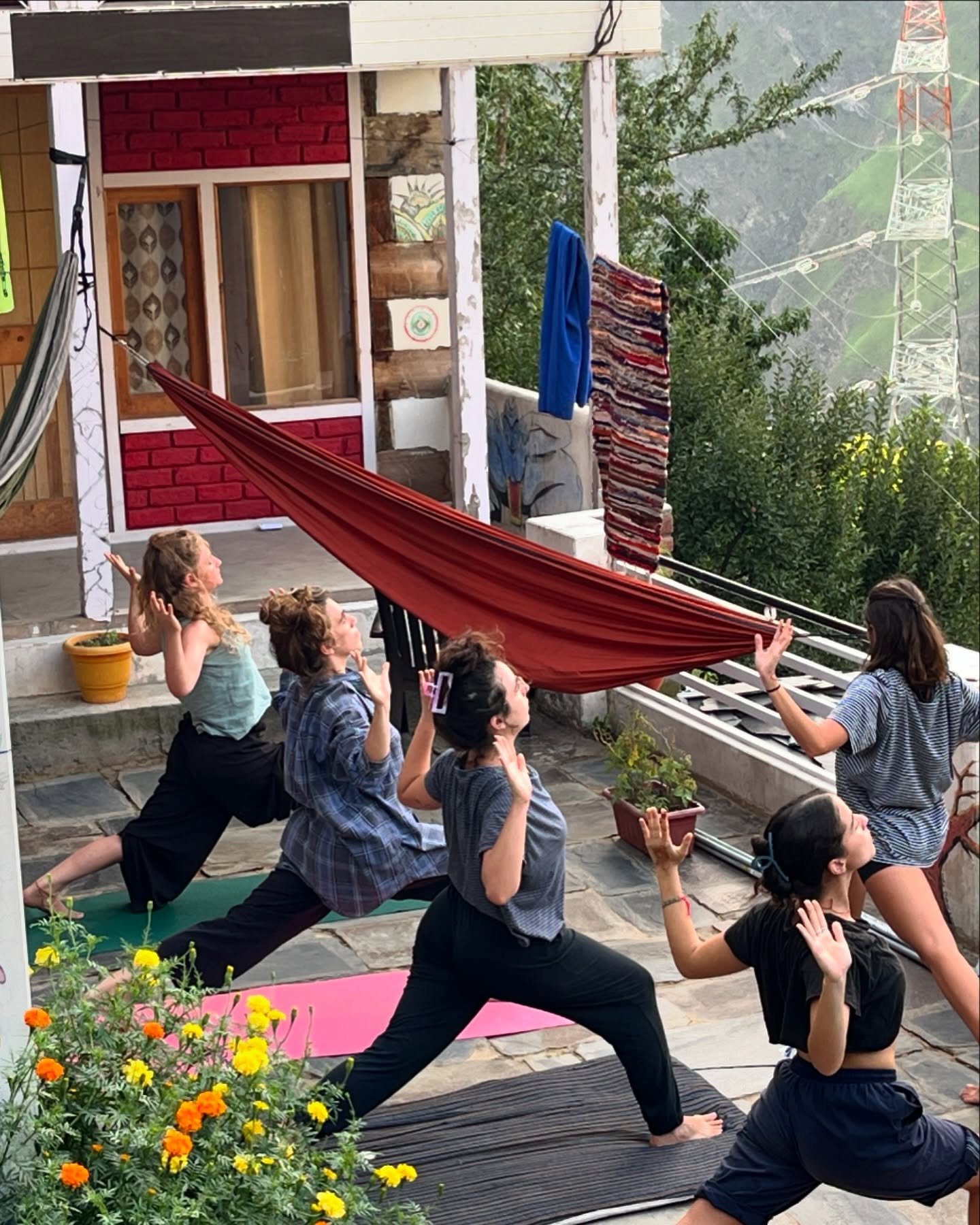 Group yoga session on a mountain homestay veranda