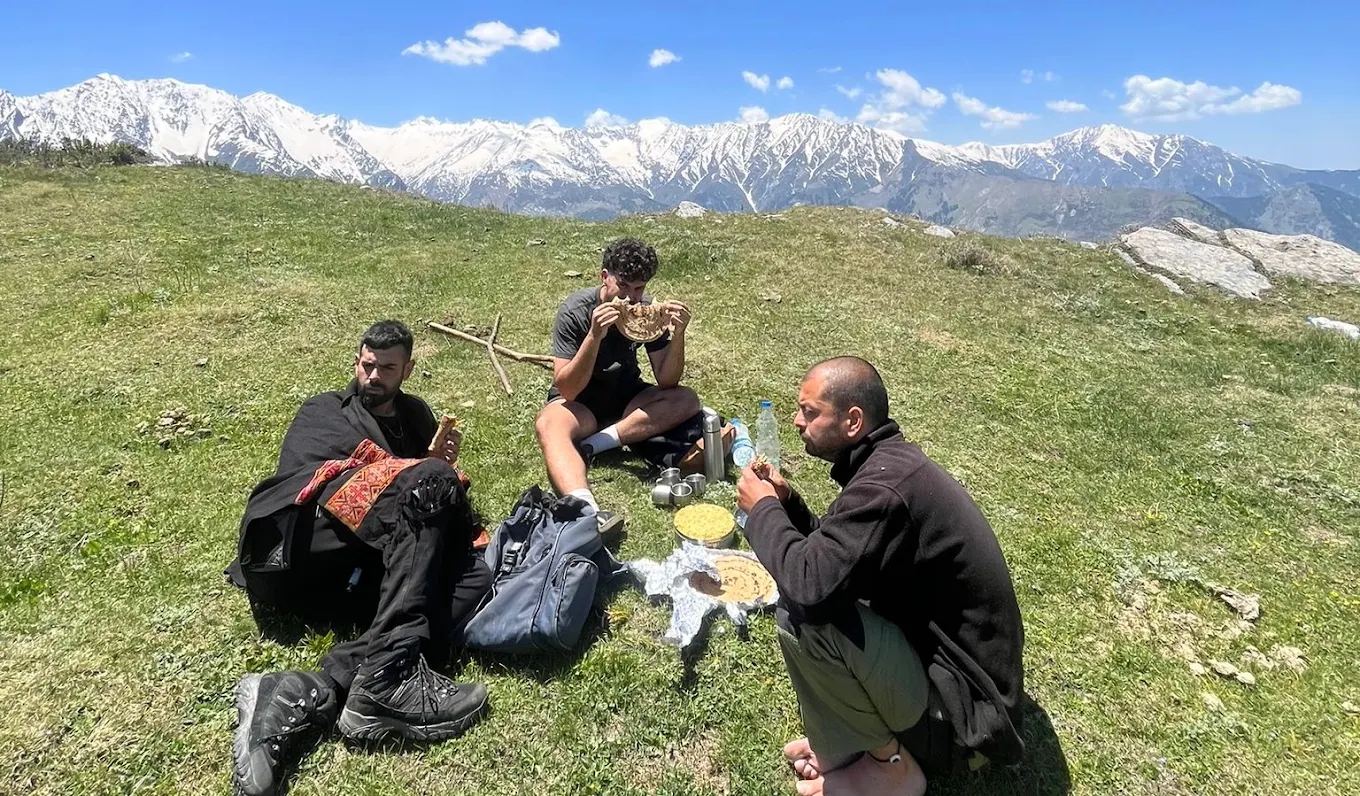 Travellers appreciating the Himalayan mountain landscape